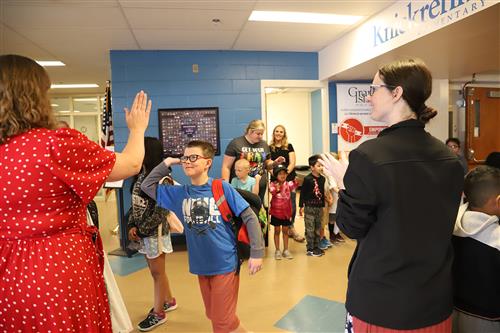 Knickrehm students high-fiving Principal Bentley